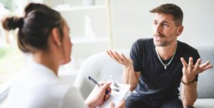 A Man with psychologist theraphy social problems concept drug addiction talk to a psychological woman